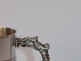 a silver cup that is sitting on a table