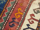 a close up of a colorful rug with a cat on it