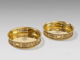 pair of gold plated bowls with floral designs