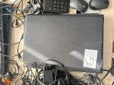 a laptop computer sitting on top of a pile of wires