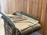 a pile of wood sitting on a pallet next to a wooden wall