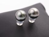 two black pearls sitting on top of a black bag