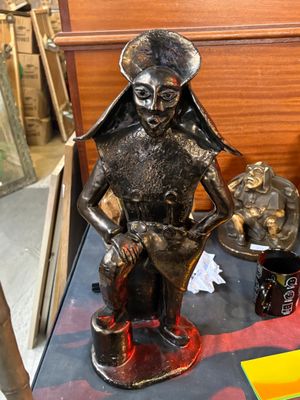 a statue of a woman holding a cat on a table