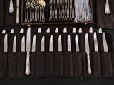 a tray with silverware and knives on a table