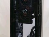 a black computer case with a fan on top of it