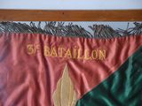 a red and green flag with a gold leaf on it