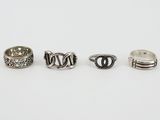 three silver rings on a white surface with a white background
