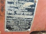 a close up of a red tractor with a sign on it
