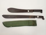 two knives and a knife sheath are sitting on a white surface