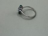an image of a diamond and emerald ring on a table
