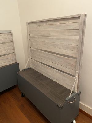 a bed with a wooden headboard on it in a room