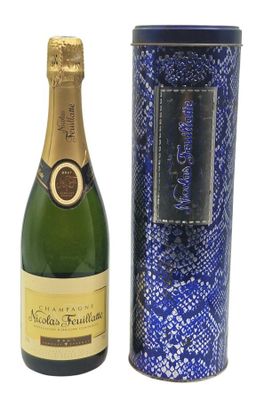the bottle of champagne is next to the box of wine
