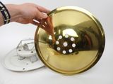 a person that is holding a golden object in their hand