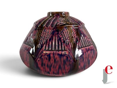 a red and black vase with a bird design on it