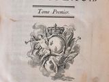 an old book with a black and white image of a woman holding a baby