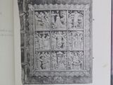 an open book with a black and white image of a stone relief