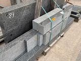 a pile of granite blocks sitting on a pallet in a warehouse