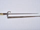 a close up of two swords on a white surface