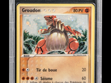a close up of a pokemon card with a picture of groudon