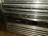 a close up of a stainless steel oven with a clock on it