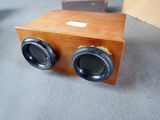 a wooden box with two speakers on top of it