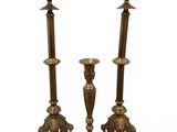 pair of antique brass candlesticks on a white background