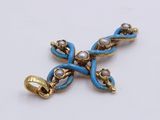 a blue and gold cross with pearls on it