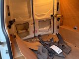 a white van with a surfboard in the back of it