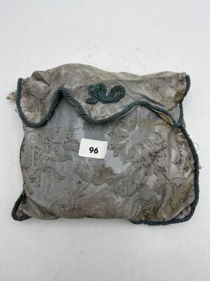 a small bag with a tag on it on a white surface
