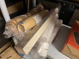 many rolls of plastic wrap on a shelf next to a box