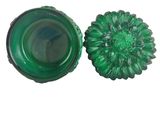 pair of green glass knobs with a flower design on them