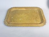 yellow glass tray with a decorative design on it on a white surface