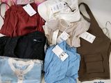 many different types of clothing on display on a table