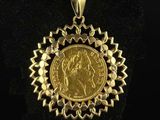 a close up of a gold coin on a black surface