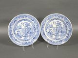 a pair of blue and white plates on stands