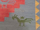 a colorful rug with a bird and a bird on it