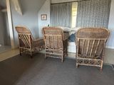 three wicker chairs in the corner of a room