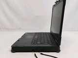 a black laptop computer sitting on a white surface