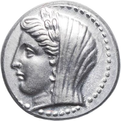 a close up of a silver coin with a woman ' s head on it