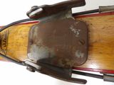 a close up of a wooden ski with a metal handle