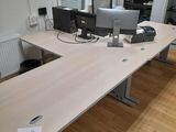 a desk with two monitors and a keyboard on it