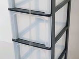 a stack of three plastic drawers on a white surface