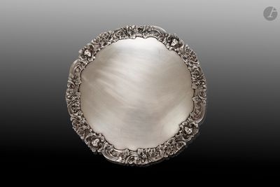 une assiette en argent antique avec un motif décoratif sur le bord
