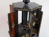 a small wooden box with scissors inside of it