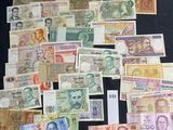 many different types of currency on a black table