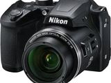 the nik digital camera is sitting on a white surface