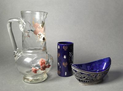 two vases and a bowl sitting next to each other on a table