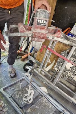 a man working on a piece of metal with a hammer