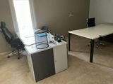a desk with a chair and a computer on it in a room