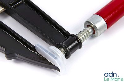 a pair of pliers with a red handle on a white surface